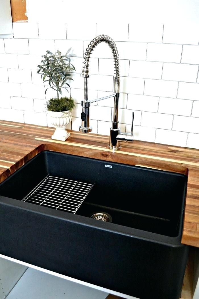 black sinks kitchen a black farmhouse sink gives our country kitchen a warm feel black kitchen sinks and taps